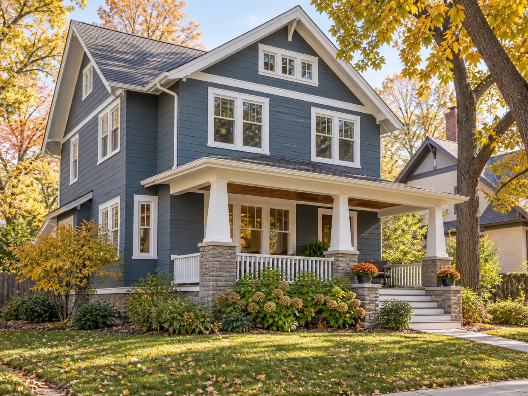 A blue craftsman home with crisp white replacement windows